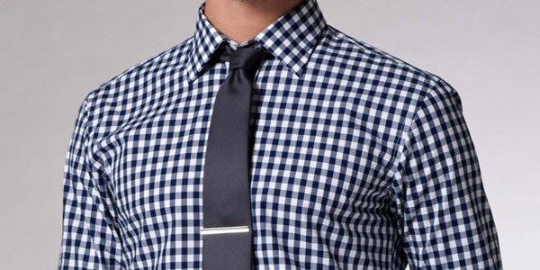 wearing a tie with a patterned shirt