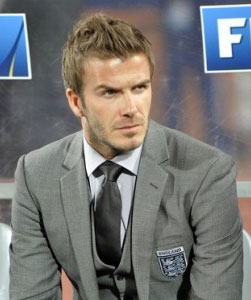 David Beckham with a pronounced jaw wearing wide-spread shirt collar with full windsor knot tie